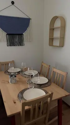 a wooden table with plates and wine glasses on it at TheTitleHalo1 in Phuket