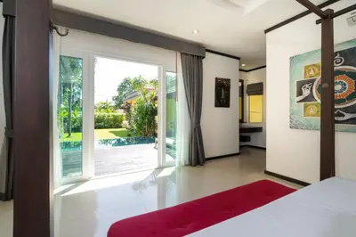 a bedroom with a bed and a large window at Villa Prima - 3 Bedroom Private Pool Villa in Rawai Beach