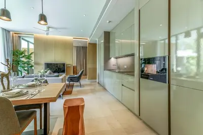 a kitchen and living room with a table and chairs at JSD Prime Property-Kamala Beach in Surin Beach