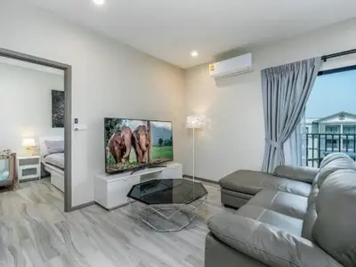 a living room with a couch and a flat screen tv at А4 Title 2-bedroom 86м2 ВатСaп66935B2I976 in Nai Yang Beach