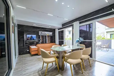 a dining room with a glass table and chairs at DreamHouse in Ban Bang Khu