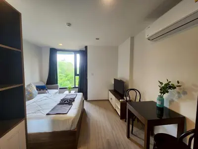 a bedroom with a bed and a table and a window at The Base Central Phuket-B32YJ in Ban Rangeng