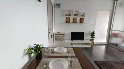a living room with two white plates and a television at dcondo Mine Phuket in Kathu