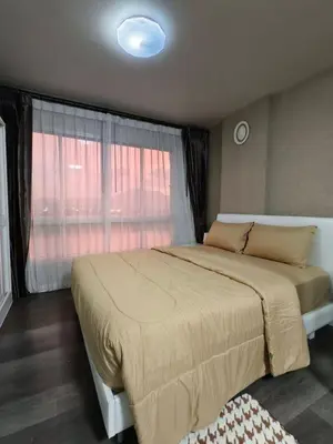 a bedroom with a large bed and a window at dcondo Mine Phuket in Kathu