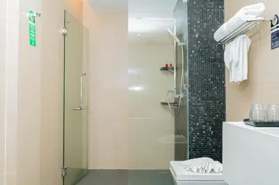 a bathroom with a shower with a toilet and a sink at Beachfront Family Pool 1 BR 1 Living Patong Phuket in Patong Beach
