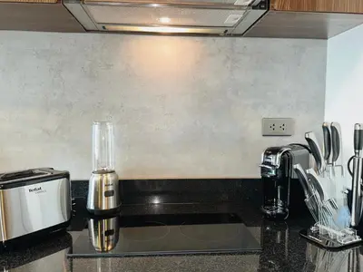 a kitchen counter with a coffee maker and a sink at Praud Karon in Karon Beach