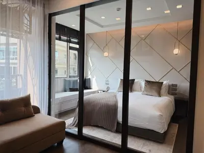 a bedroom with a bed and a large mirror at Proud Karon 303 in Karon Beach