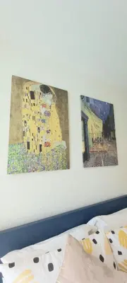 a bedroom with two paintings on the wall and a bed at MO1 Halo 2-bedroom ВатСaп66935B2I976 in Nai Yang Beach