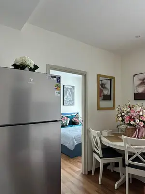 a kitchen and dining room with a refrigerator and a table at MO1 Halo 2-bedroom ВатСaп66935B2I976 in Nai Yang Beach
