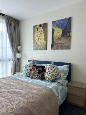 a bedroom with a bed with three paintings on the wall at MO1 Halo 2-bedroom ВатСaп66935B2I976 in Nai Yang Beach