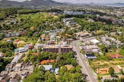 an aerial view of a city with houses and a road at Room 402 Rawai Beach Condo in Nai Harn Beach