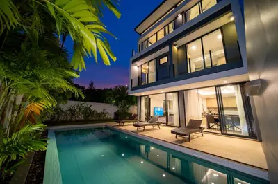a house with a swimming pool next to a house at Modern Minimalist 6 Bedroom Light Luxury Villa Private Pool Golf Course Laguna Park in Bang Tao Beach
