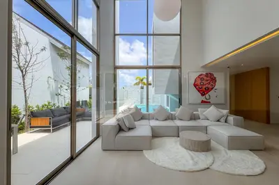 a living room with a white couch and a table at Brand-New 3BR Designer Pool Villa in Exclusive Residence LuxPride 4 L20 in Bang Tao Beach