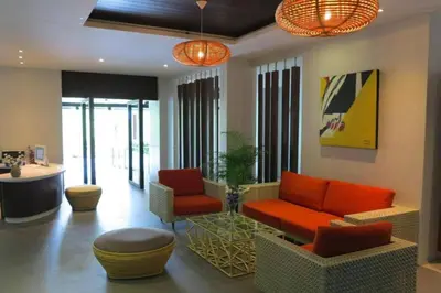 a living room with a couch and chairs and a counter at Tropical Retreat near Patong - Emerald Hill 420 in Patong Beach