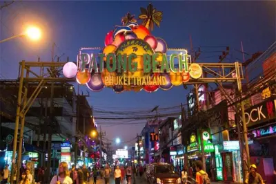a busy city street at night with a neon sign at Tropical Retreat near Patong - Emerald Hill 420 in Patong Beach