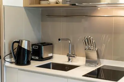 a kitchen counter with a sink and a coffee maker at Laguna Skypark spacious 1 bedroom apart Bangtao in Laguna Phuket