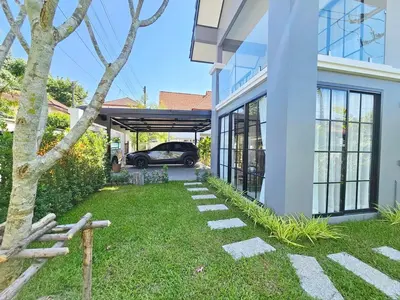 a house with a car parked in the driveway at Modern 2 Bedroom Pool Villa in Kamala in Kamala Beach