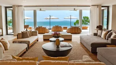 a living room with couches and a table at Villa Amarapura in Ko Lek