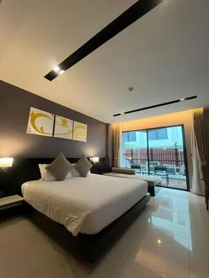 a bedroom with a large bed and a large window at Beachfront Deluxe BR Infinity Pool Patong Phuket in Patong Beach