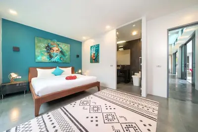 a bedroom with a bed and a blue wall at Unique Style & Comfort, 2BR Pool Villa DannyLys, near Nai Harn in Rawai Beach