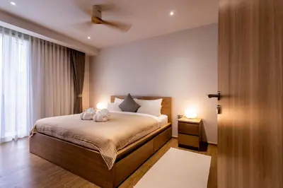 a bedroom with a bed with two stuffed animals on it at Cozy 1 BR beachfront apartment in Bang Tao Beach