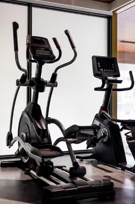 a gym with two exercise bikes and a treadmill at Cozy 1 BR beachfront apartment in Bang Tao Beach