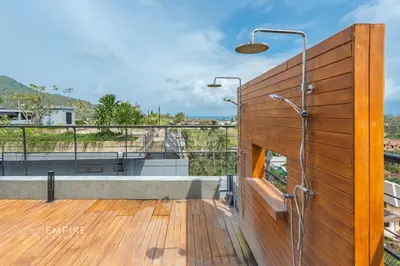 a bathroom with a shower on a wooden deck at CityGate Kamala 1BR 3 min Beach in Kamala Beach