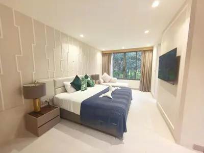 a bedroom with a large bed with a blue blanket at \u7af9\u5149\u522b\u9662 Bamboo Radiance Villa in Ban Thalat Choeng Thale