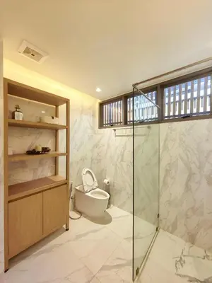 a bathroom with a toilet and a glass shower at \u7af9\u5149\u522b\u9662 Bamboo Radiance Villa in Ban Thalat Choeng Thale
