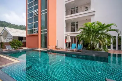 a swimming pool in front of a building at Patong612\u7cbe\u88c5\u4e00\u5367\u516c\u5bd3 \u7535\u68af\u6cf3\u6c60\u5065\u8eab\u623f \u6b65\u884c\u591c\u5e02\u6d77\u6ee9 in Patong Beach