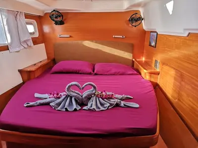 a bed with two heart shaped decorations on it at Catamaran Lagoon 440 Calypso in Ban Bang Chak