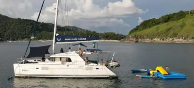 a white boat is docked in the water at Catamaran Lagoon 440 Calypso in Ban Bang Chak