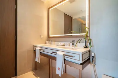 a bathroom with a sink and a mirror at Angsana Oceanview Residence Luxurious 2BR Lakeview Apartment in Laguna Phuket