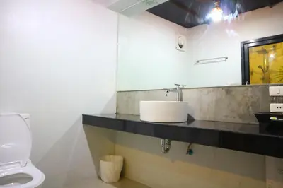 a bathroom with a sink and a toilet at Baan Norkna Bangtao in Bang Tao Beach