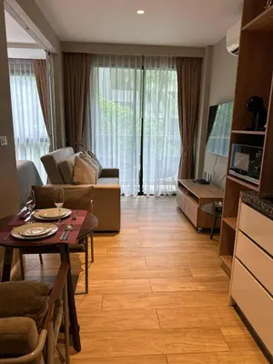 a living room with a table and a couch at Diamond Condominium 1 BR Bangtao beach in Bang Tao Beach