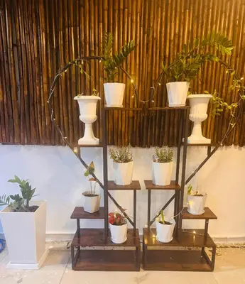 a plant stand with potted plants on it at SET INN restaurant & bar in Kata Beach