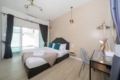 a bedroom with a bed and a desk and a glass table at 6BDR patong pool villa by Mp property in Patong Beach