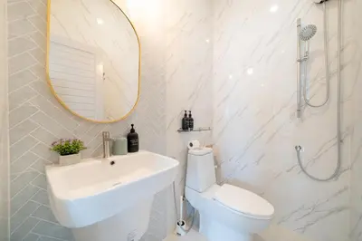 a bathroom with a sink and a toilet and a mirror at 6BDR patong pool villa by Mp property in Patong Beach