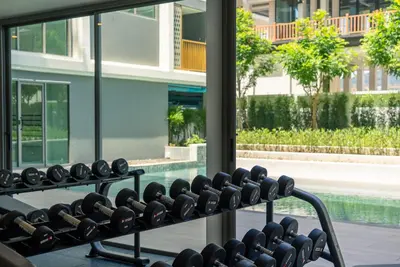 a rack of wine bottles in a window in a building at The Ozone Residences Bangtao in Phuket