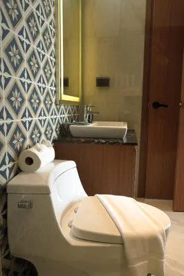 a bathroom with a white toilet and a sink at The Ozone Residences Bangtao in Phuket