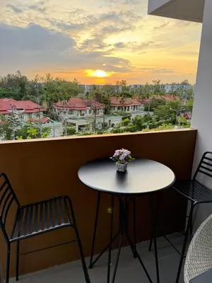 a table and chairs on a balcony with a view at 2BR Rooftop Pool & Gym Laguna Skypark in Laguna Phuket