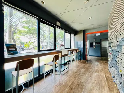 a row of chairs in a waiting room with windows at Zcape 2 Phuket by RESAVA in Bang Tao Beach