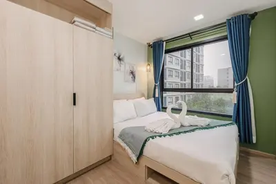 a bedroom with a bed with a large window at C210 Peaceful Retreat in Heart of Phuket in Kathu