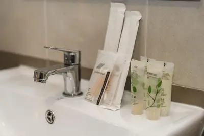 a bathroom sink with toothbrushes and towels on it at C210 Peaceful Retreat in Heart of Phuket in Kathu