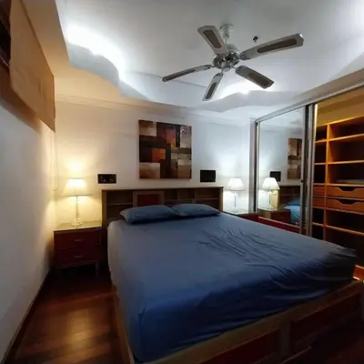 a bedroom with a bed and a ceiling fan at Private 2 Bedroom Seaview at Patong Phuket in Patong Beach
