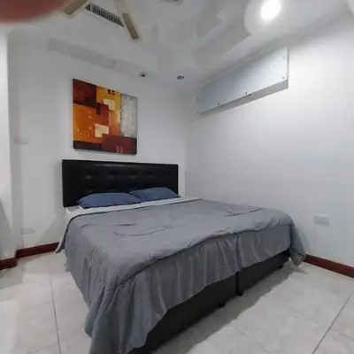 a bedroom with a bed in a white room at Private 2 Bedroom Seaview at Patong Phuket in Patong Beach