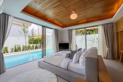 a bedroom with a large bed and a swimming pool at New Tropical Modernity! 3BR Pool Villa LuxPride4 L21 near Laguna Phuket in Bang Tao Beach