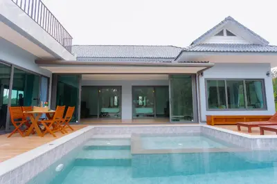 a villa with a swimming pool and a house at Seashine Private Pool Villa at Klong Muang in Klong Muang Beach