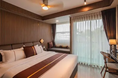 a bedroom with a large bed and a window at The Legacy V Beachfront Resort Ao Nang Krabi, Aspira Collection - Adults only in Ao Nang Beach