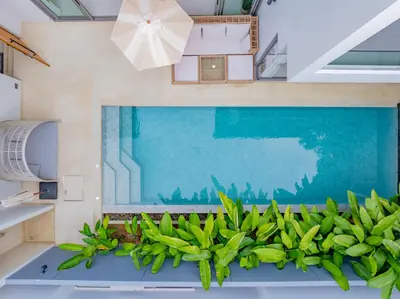 a view of the pool from the balcony of a house at 3BR Villa Z by NLA in Bang Tao Beach